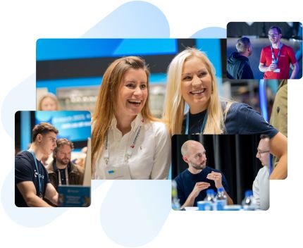 Professionals networking and conversing at a conference, featuring men and women smiling and interacting.