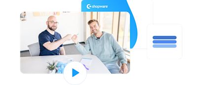 Dive deep Zwei Shopware-Mitarbeiter sitzen an einem Tisch und geben sich einen Fauststoß, während sie in die Kamera lächeln. Im Hintergrund ist das Shopware-Logo zu sehen. Ein Play-Symbol deutet auf ein Video hin.
