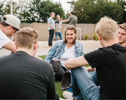 Person sitting in a circle and enjoying each others company.