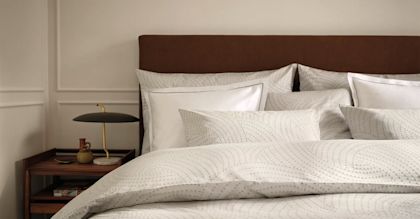 Light coloured bedroom with floral bedsheets