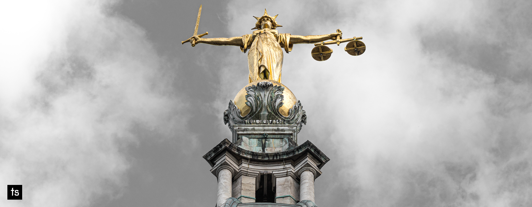 Lady Justice statue atop the Old Bailey in London, holding scales and a sword