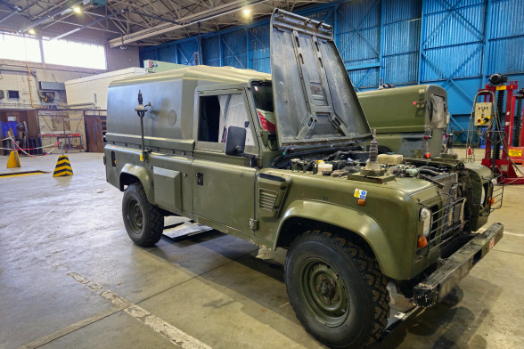 Mechanical engineers working on an Army Land Rover in a workshop