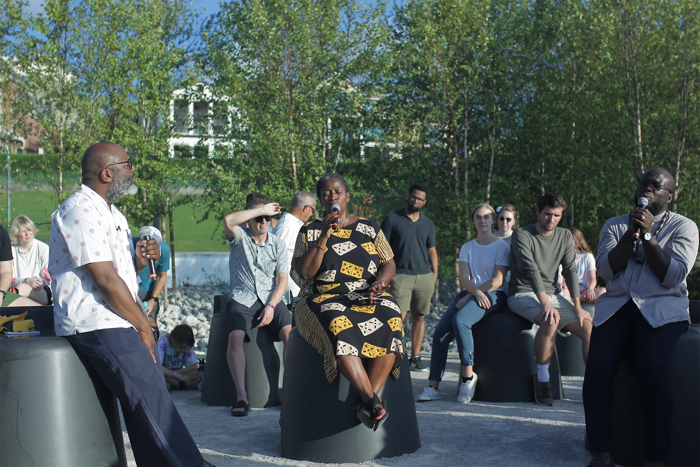 A diverse group of individuals gathered at the Monument to Listening