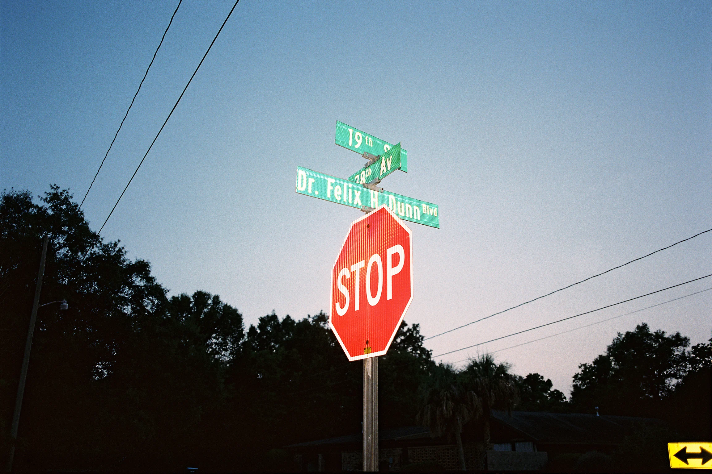 Stop sign and cross-streets at Felix Dunn House