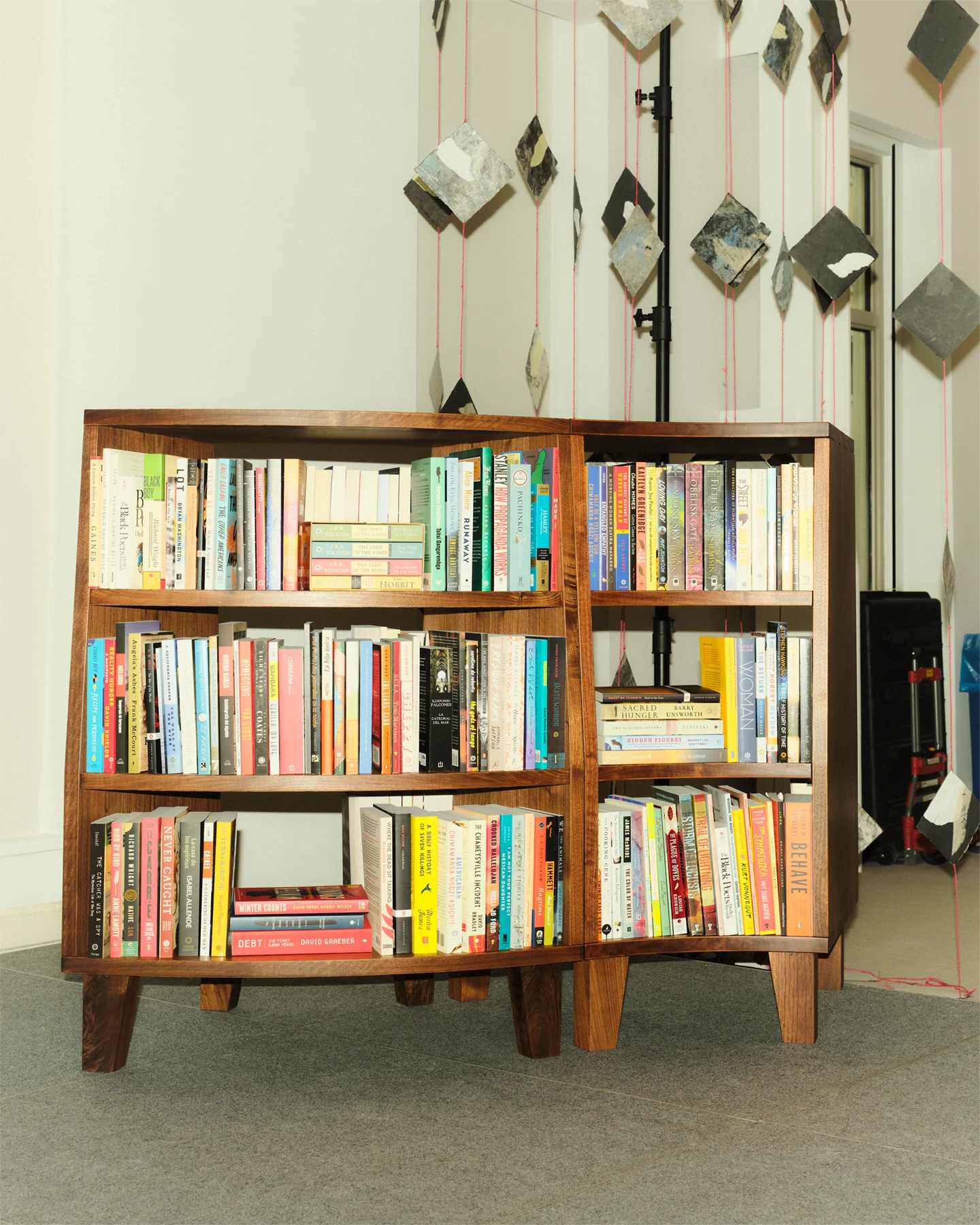 A specially designed bookshelf containing an assortment of books 
