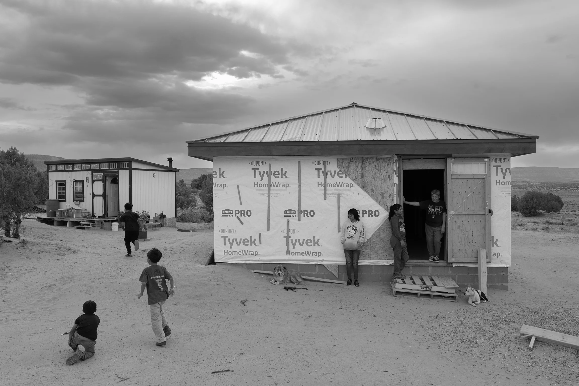 A house in the process of being built sits in a desert landscape 
