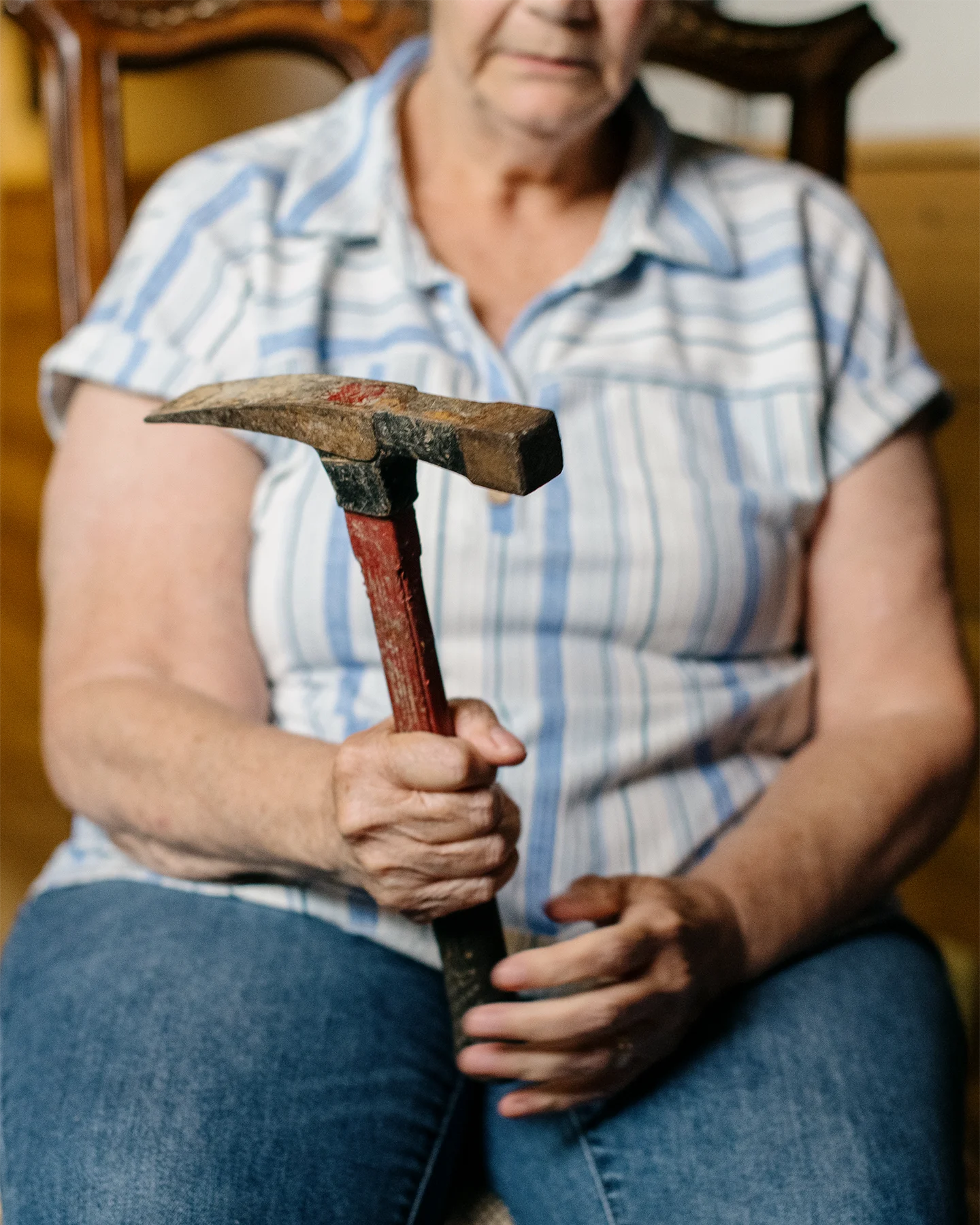 Person holding a historic coal mining pickaxe used by a family member who worked in the mines.