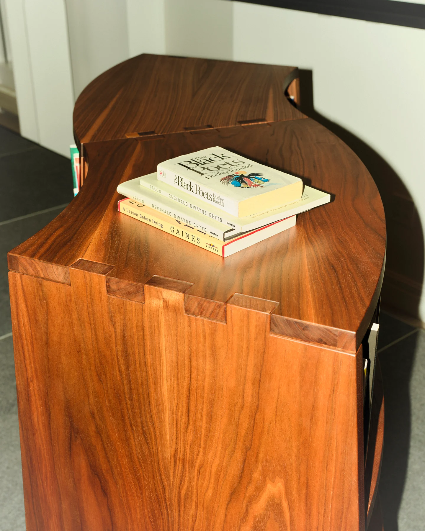 A view of a specially created bookcase with four books displayed on the top of the case