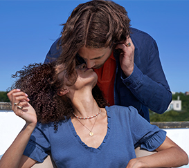 Hombre besando a una mujer con el pelo rizado