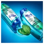 dos botellas acostadas de champú H&S LIMPIEZA PROFUNDA ALIVIA EL PICOR y hojas de menta entre ellas
