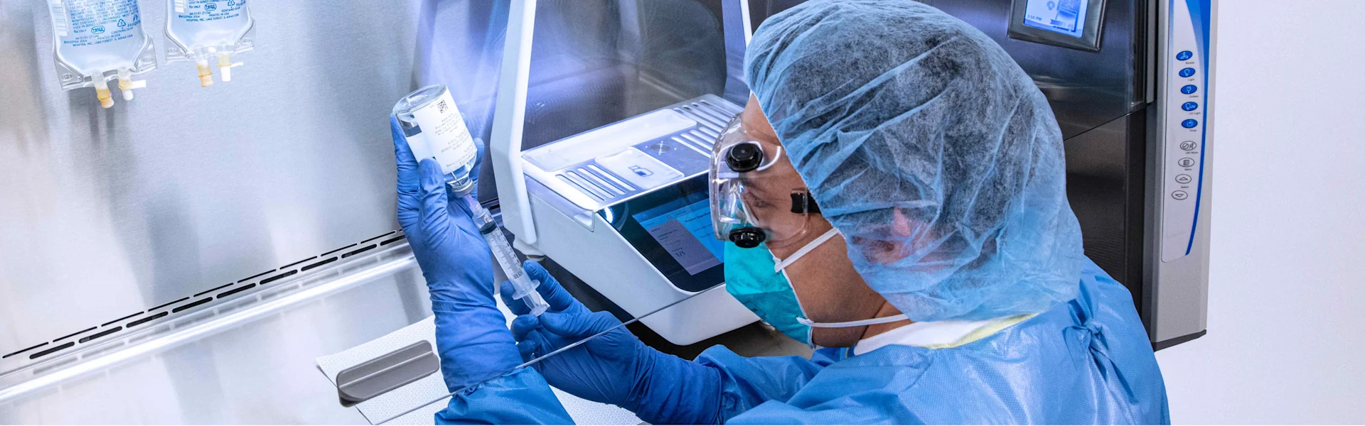 A pharmacist extracting medicine from a vial.