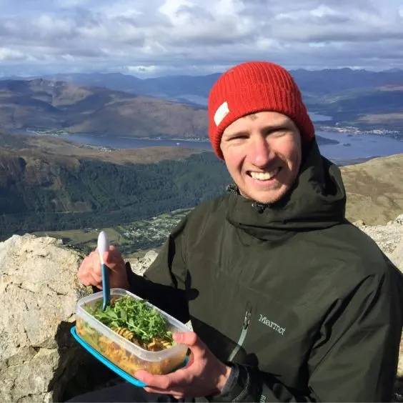 Man on top of Ben Nevis eating packed lunch