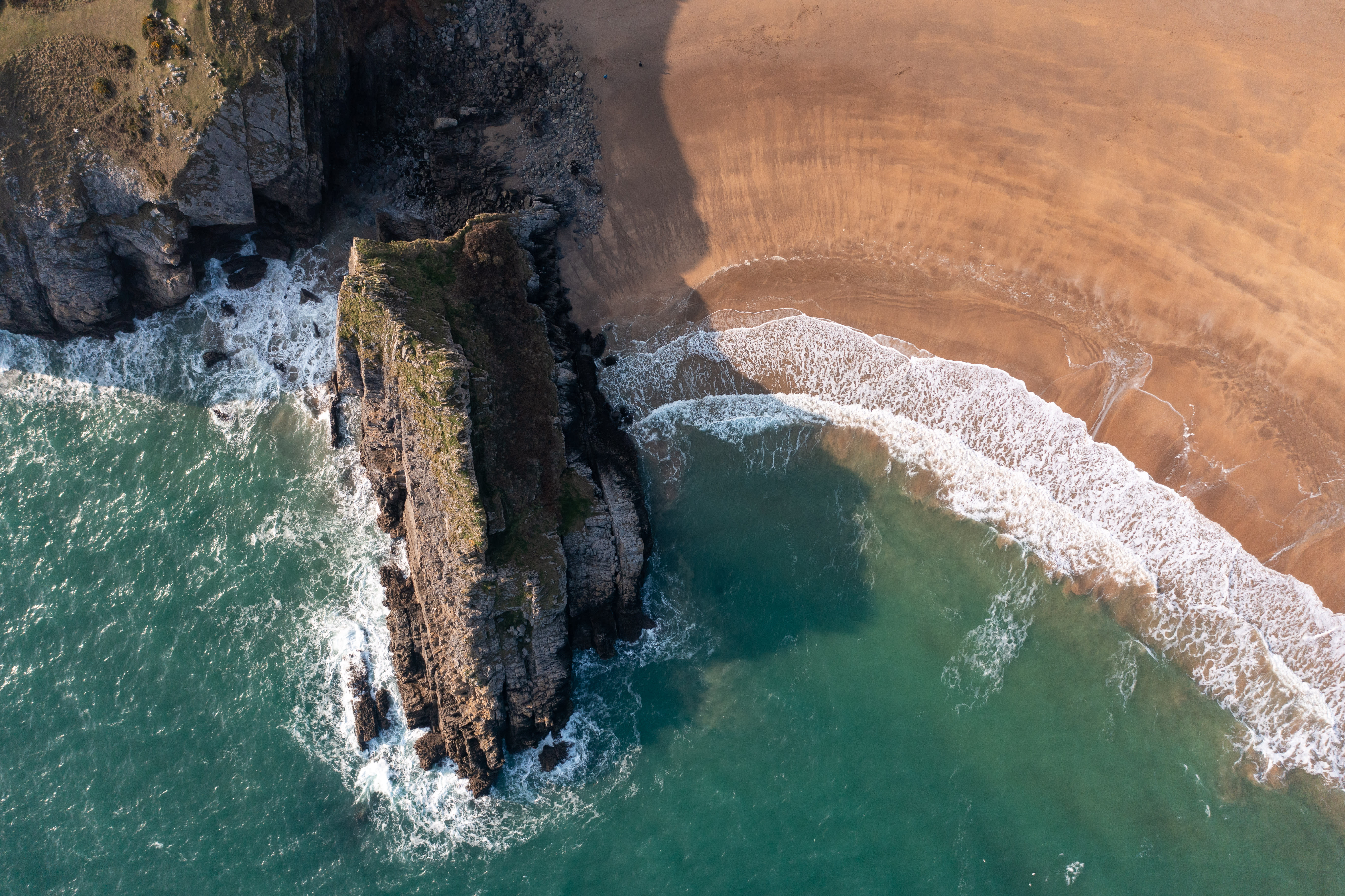 Aerial view of the sea, a cliff and beach on the Pembrokeshire coast 2023.