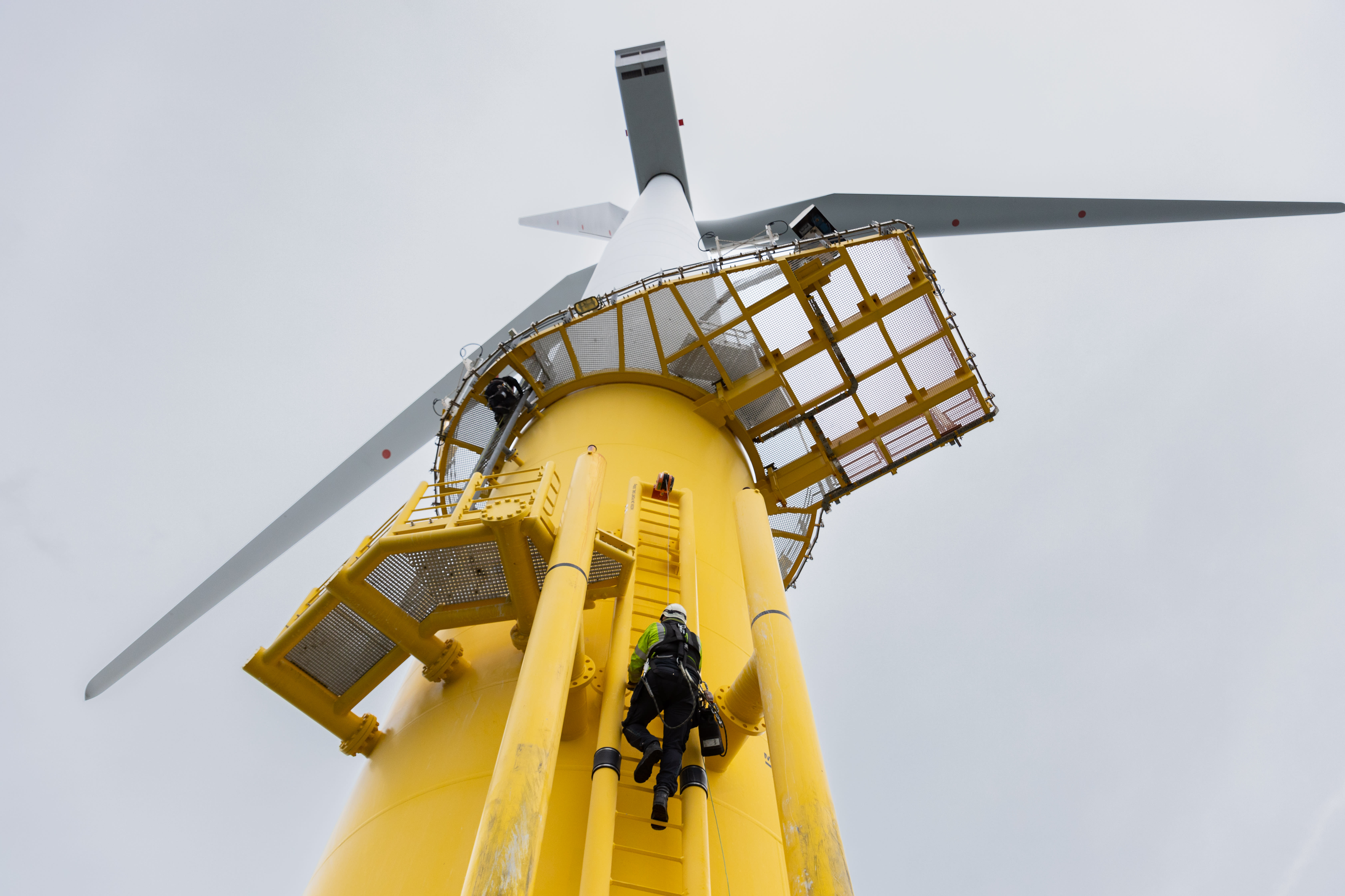 Person climbing up offshore wind turbine