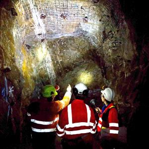 People in high vis jackets and hard hats in a mine