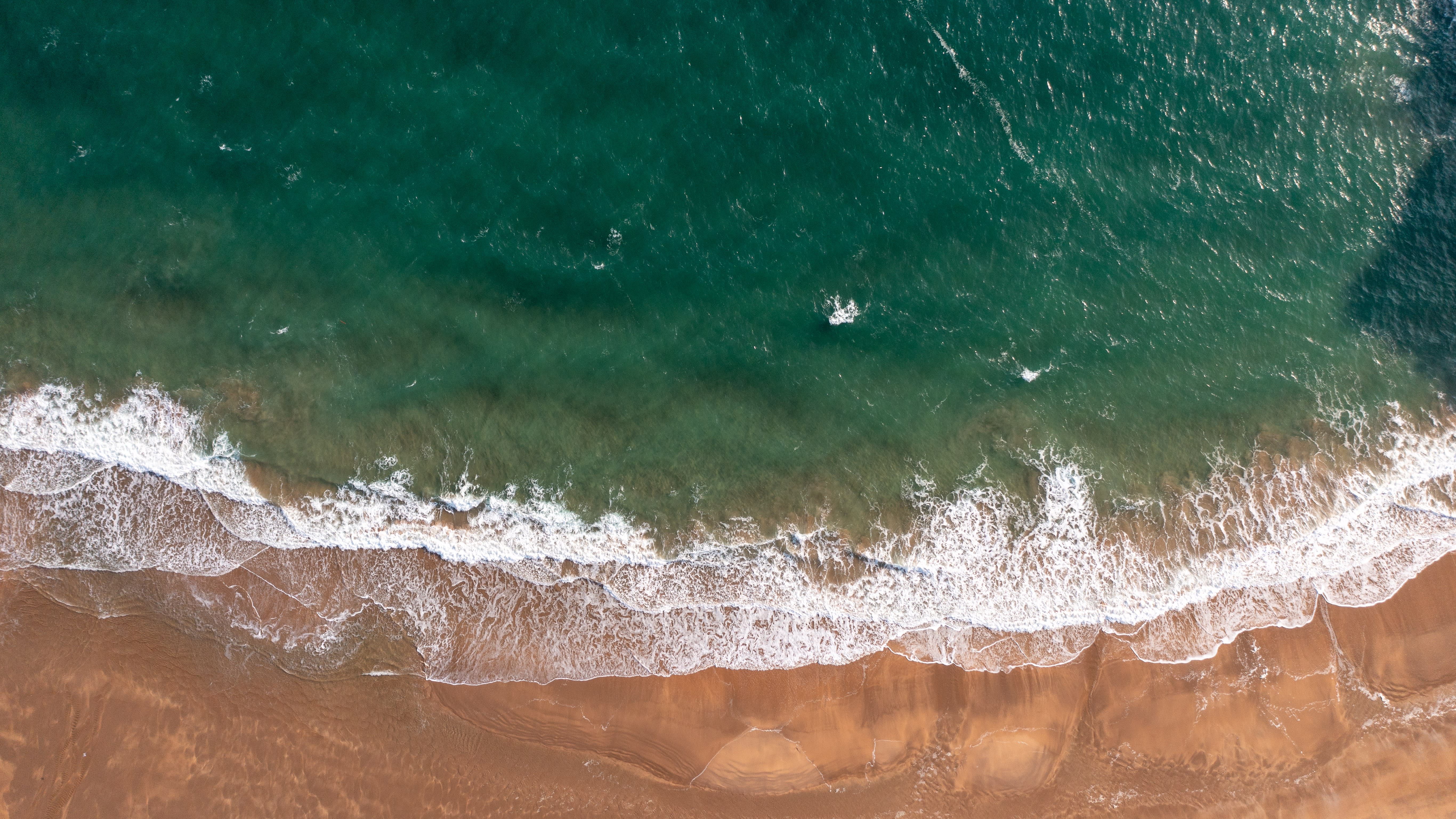 Aerial shot of waves breaking on the beach
