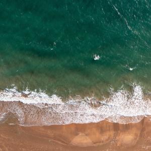 Aerial shot of waves breaking on the beach