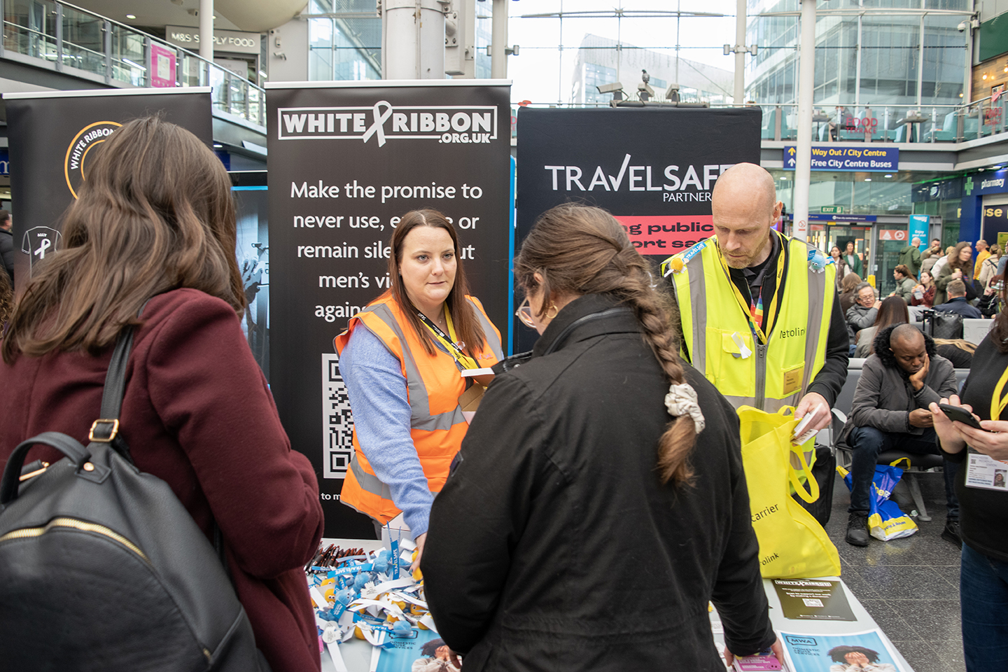 TfGM staff speaking to members of the public at a white ribbon event 