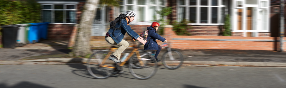 Two people riding bikes on a street