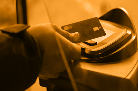 A person making a contactless payment on a bus