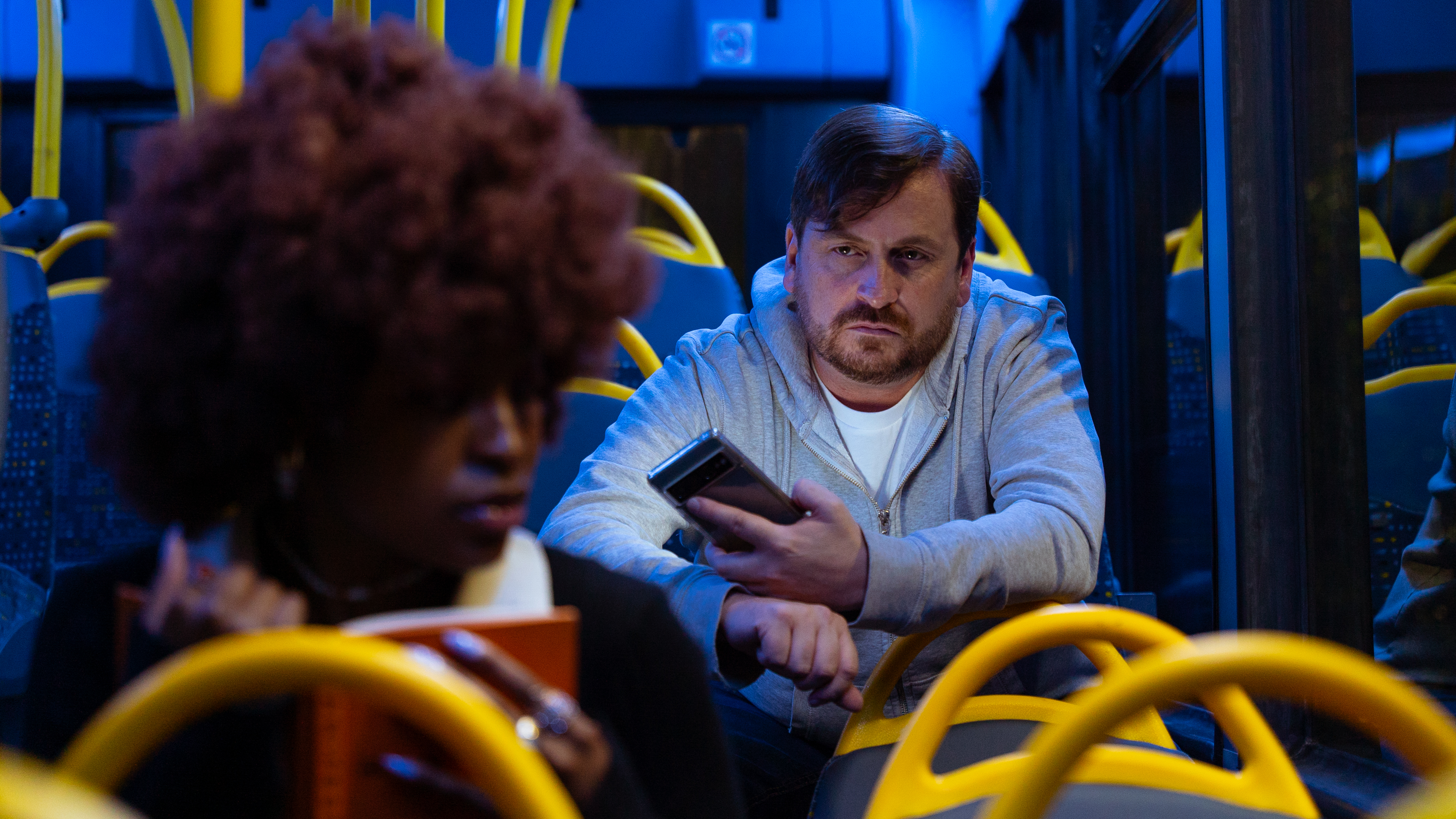 Man staring at a woman on a bus