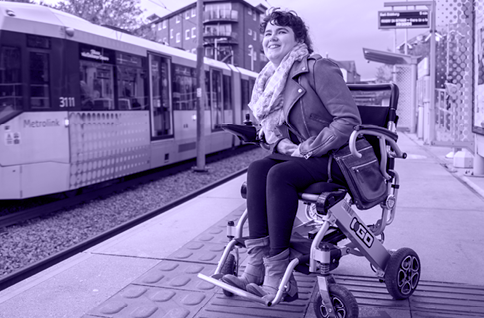 Woman in a wheelchair waiting for the tram in Manchester