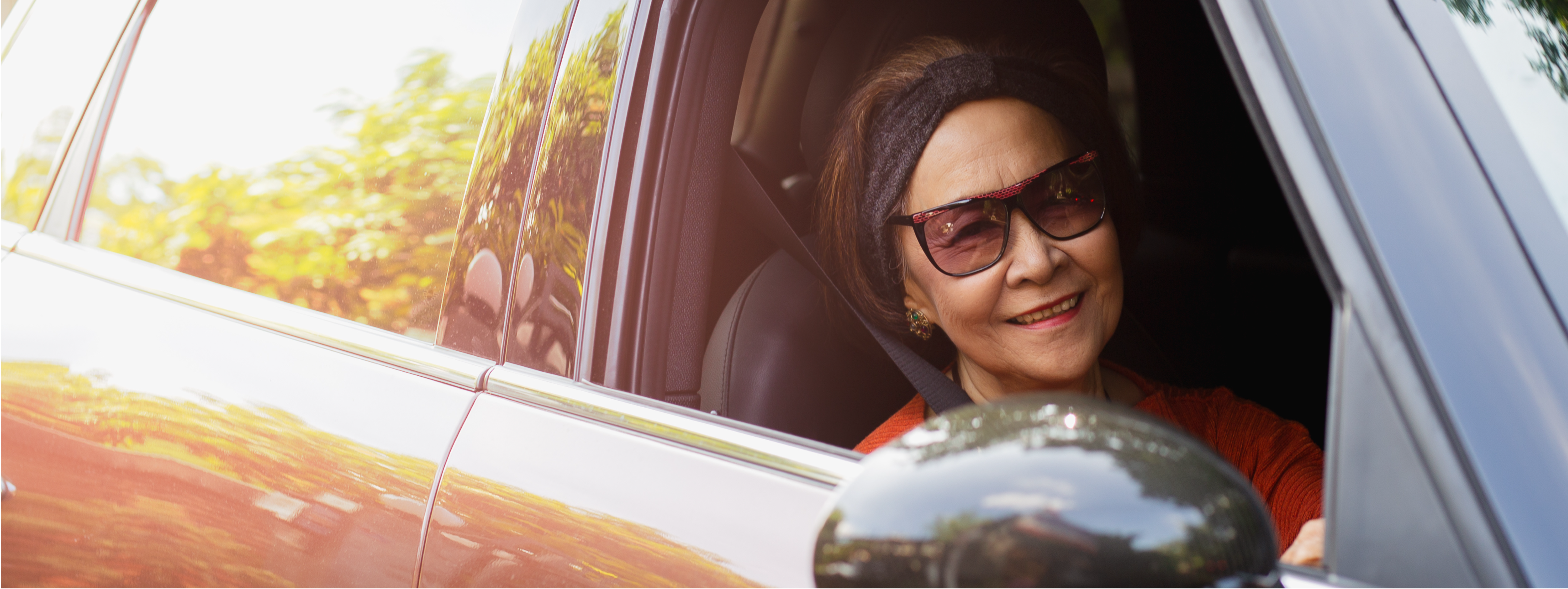 Older person driving a car as part of a free safety course