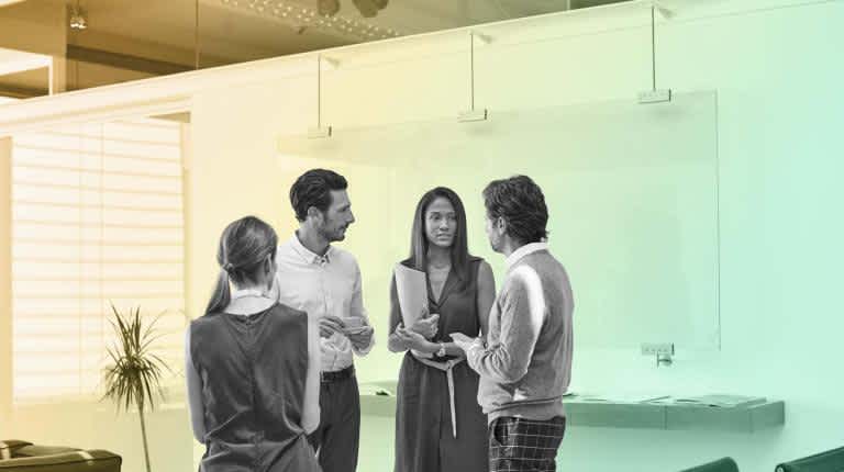 Four people standing having a conversation on Reports
