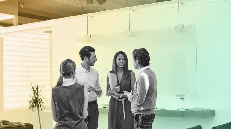Four people standing having a conversation on Reports