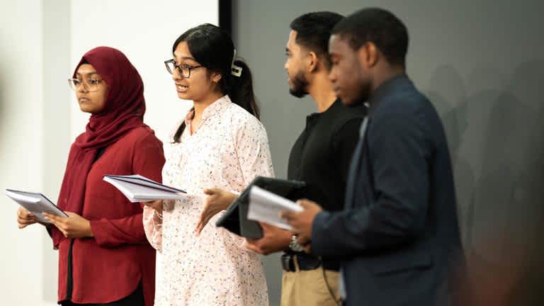 Four people from diverse ethnicity background standing together on Employability