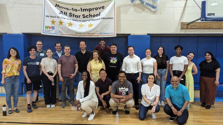 Fitch employees posing for a photo in a basketball court on Volunteering And Fundraising
