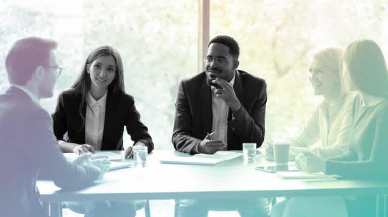 A group of employees having a meeting at a table