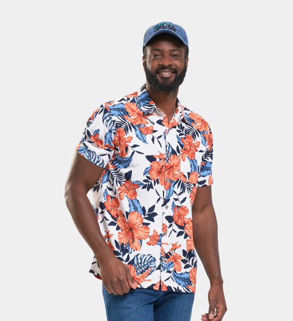 Male model wearing a blue cap, white dress shirt that buttons up and has an all-over print.