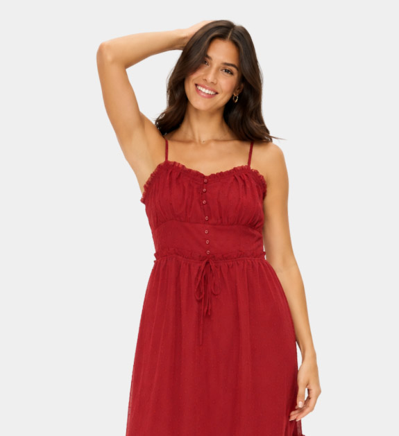A model wearing a red spaghetti strap dress. 