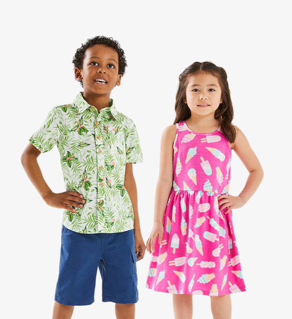boy model wearing a green tropical printed button up shirt with blue shorts and a girl model wearing a pink and white dress with ice cream prints