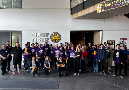 The team from Merge Robotics standing together in the Giant Tiger warehouse. 