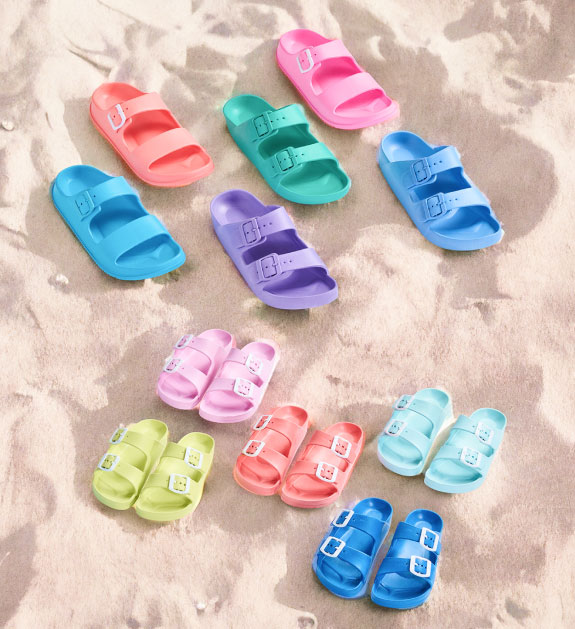 various pairs of sandals and slides in different colours.