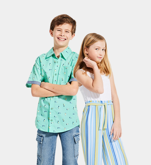 boy model wearing aqua green printed collared shirt and blue jeans and girl model wearing a romper that features a white top and blue, yellow and white striped bottoms