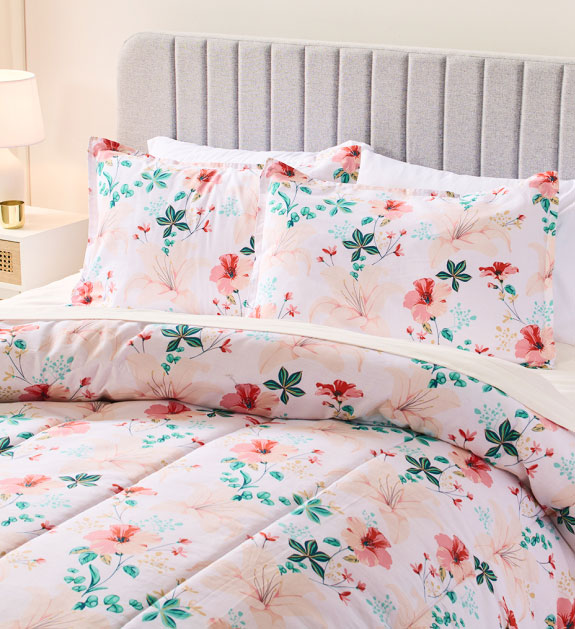 White comforter set with pink and green floral print