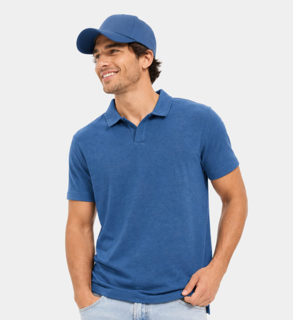 A model wearing a a short sleeve blue collared top and blue cap.