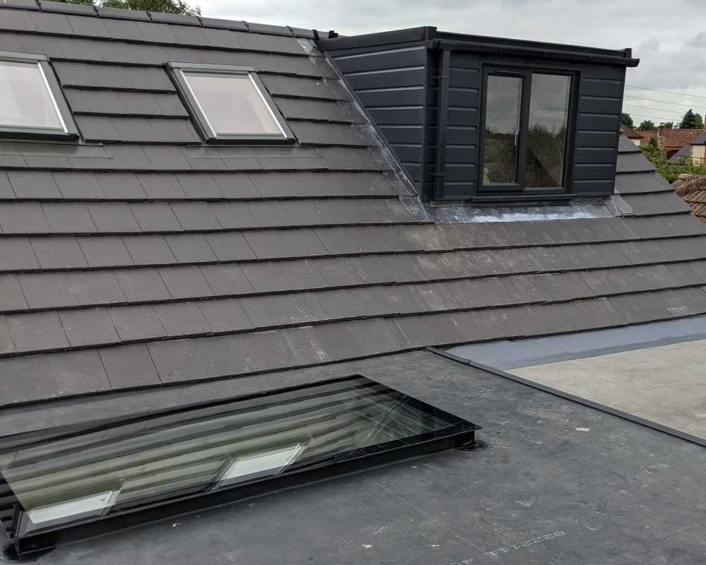 Triple glazed and toughened flat roof skylights fitted to a rubber warm flat roof.