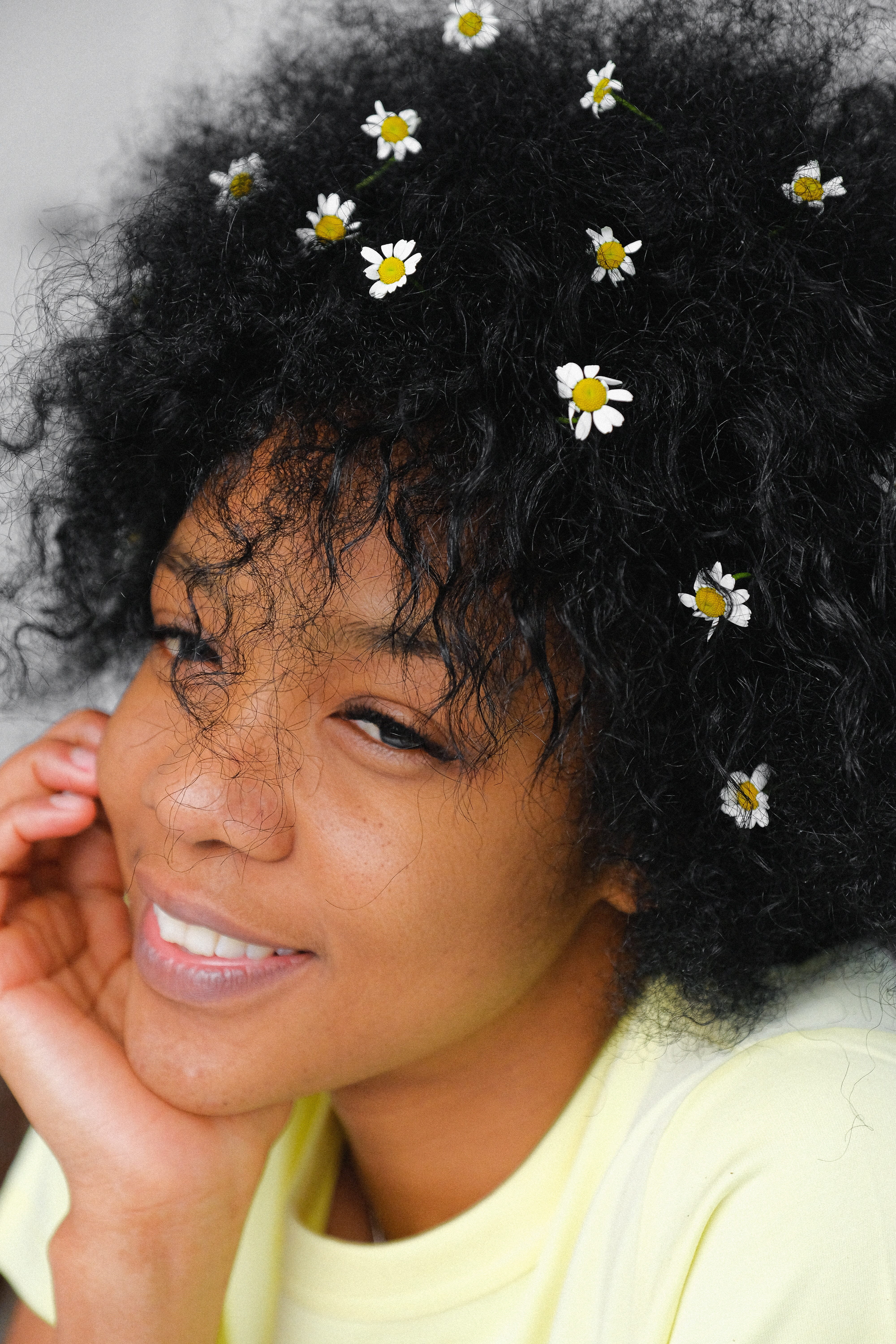 woman with curly hair flowers big chop