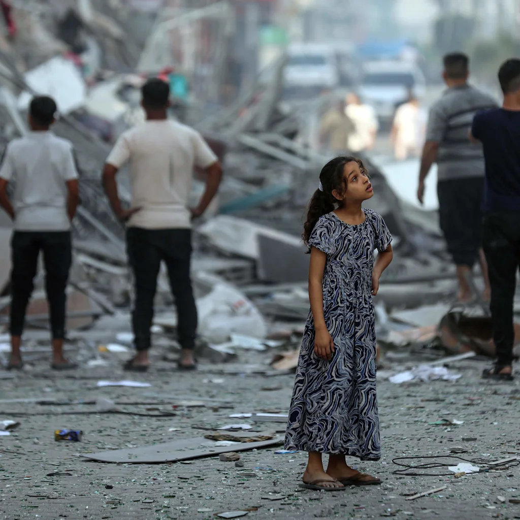 Girl standing on the street amongst ruins - UNICEF