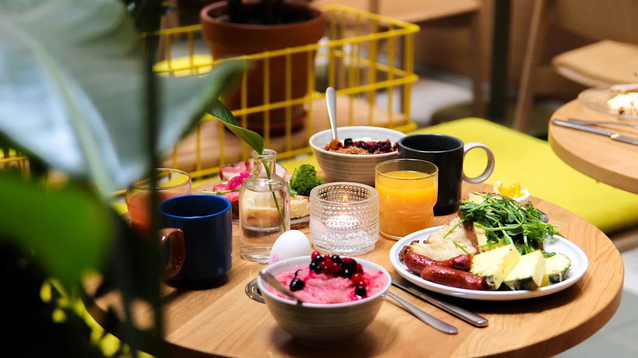 A delicious and varied breakfast spread on a wooden table in a cozy setting.