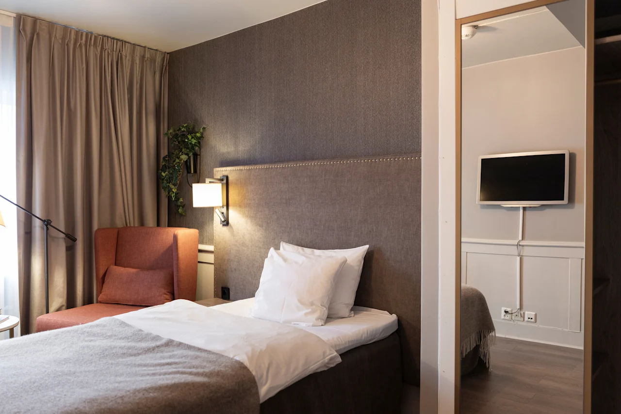 A welcoming hotel room at Home Hotel Grand Bodø, offering a comfortable space for rest and relaxation.