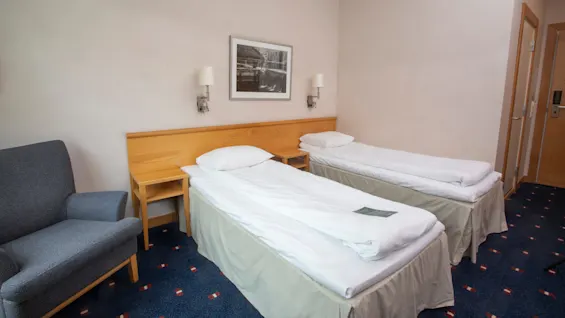 Standard twinroom at Home Hotel Bryggeparken, made beds.