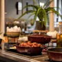 A beautifully arranged warm buffet featuring savory dishes and fresh oil, inviting guests at Home Hotel Grand Bodø.