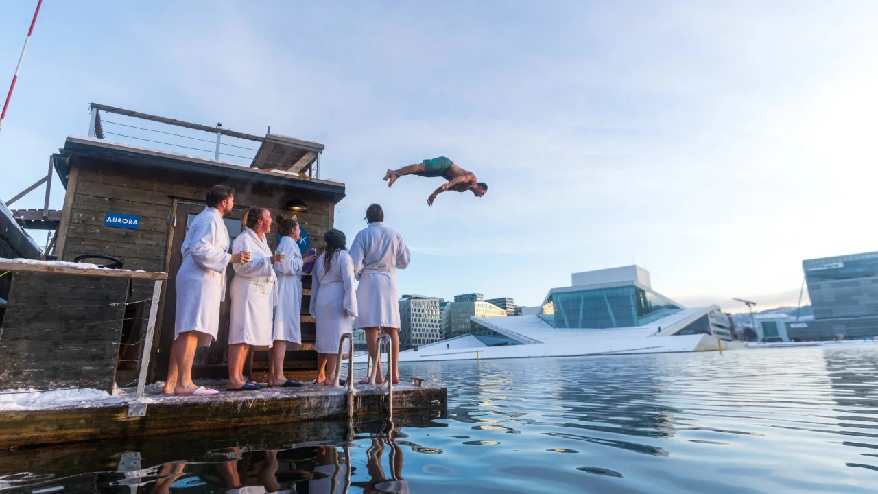Man jumping into the water from the sauna in Oslo.