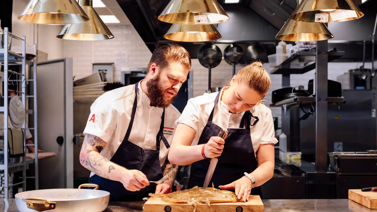 Chefs in the kitchen of Atlas Brasserie & Café in Oslo.