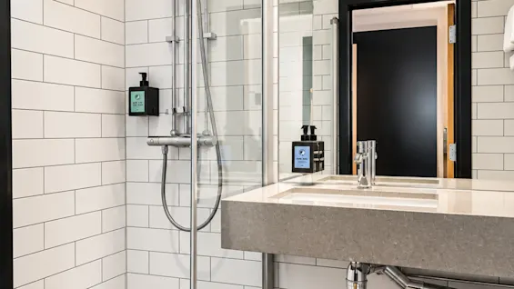 Modern bathroom featuring a white tiled shower and sink